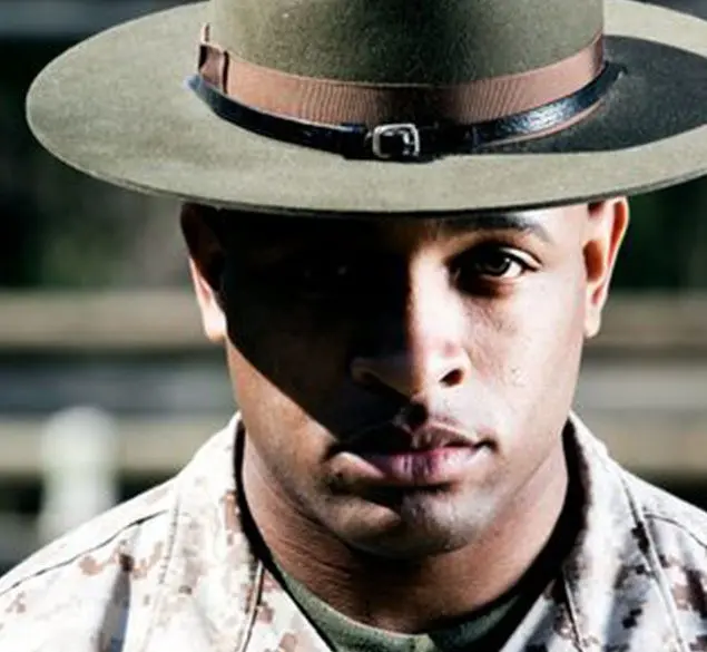 A man in uniform with a hat on.